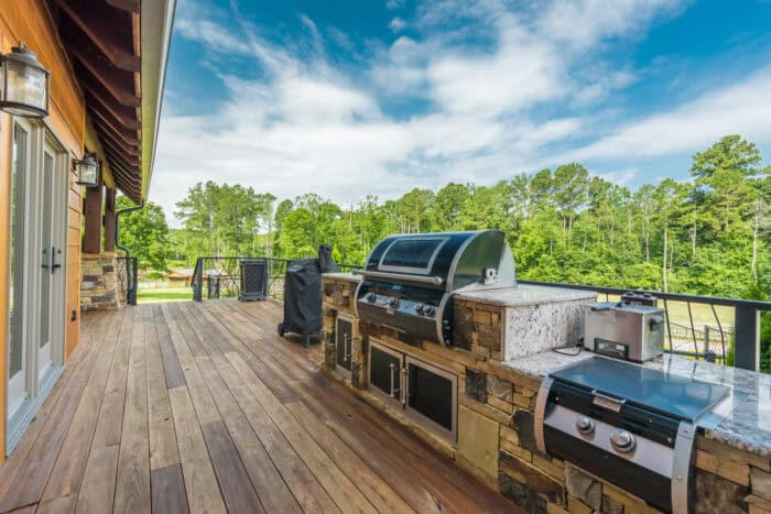 Elegant log cabin with natural materials, set in a lush mountain landscape, showcasing custom crafts.