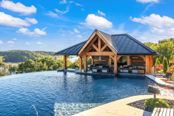 Custom log cabin with timber frame design overlooking a scenic lakeside setting.