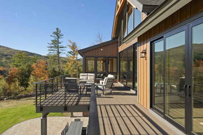 Modern timber frame home with natural materials in mountain setting, perfect for custom log cabin li.