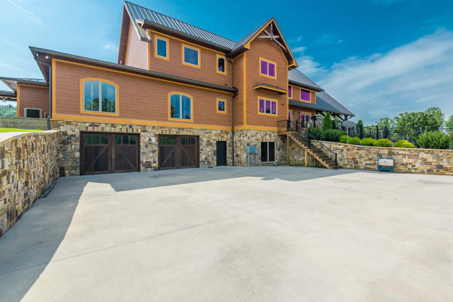 Custom mountain log cabin with timber frame accents and natural stone foundation.